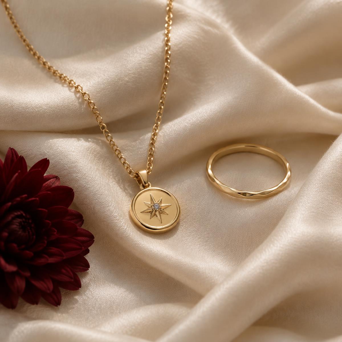 Gold pendant and ring on ivory silk